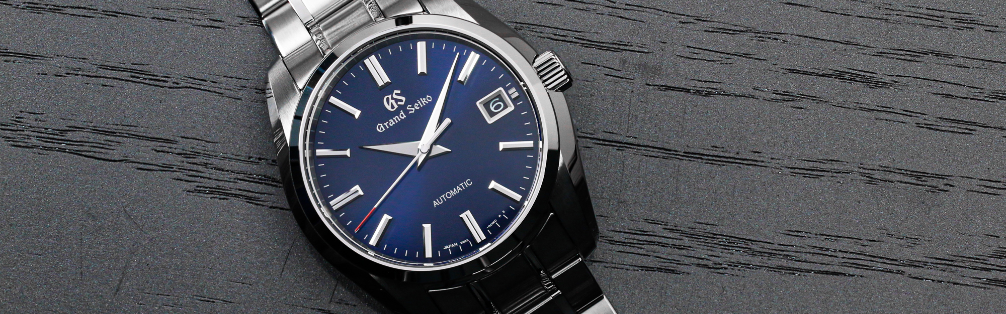 Frozen waterfall Jily Su in winter. Landscape of mountains with Grand_Seiko_Spring_Drive_GMT_SBG295-hero-thumbnail